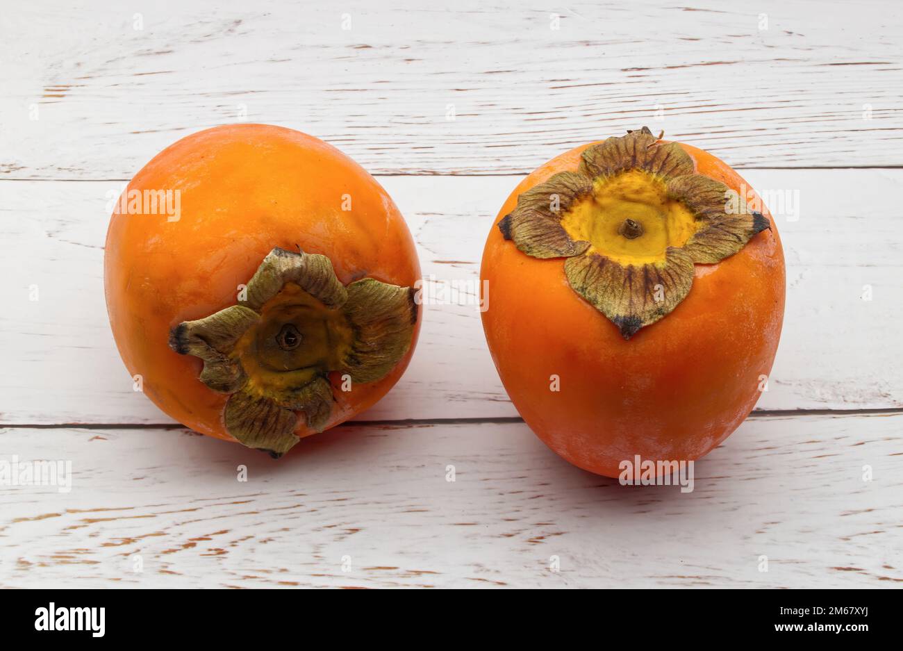 Fresh ripe persimmons isolated on white background Stock Photo