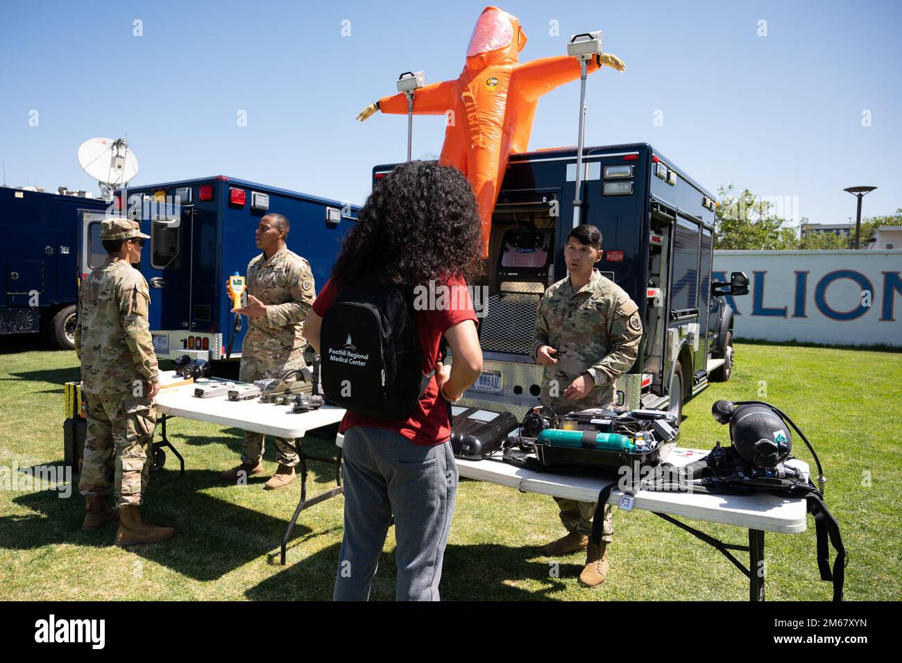 U.S. Army 1st Lt. Demetrious Pitsikos, right, a survey team leader with the California National Guard’s 9th Civil Support Team (Weapons of Mass Destruction), talks with a student on the campus of California State University, Fullerton, during the college’s Military Exhibition Day, April 14, 2022, in Fullerton, California. The event was organized by the school’s ROTC program and offered an opportunity for cadets and students to learn about ways to serve in the National Guard and U.S. Army Reserve. Stock Photo