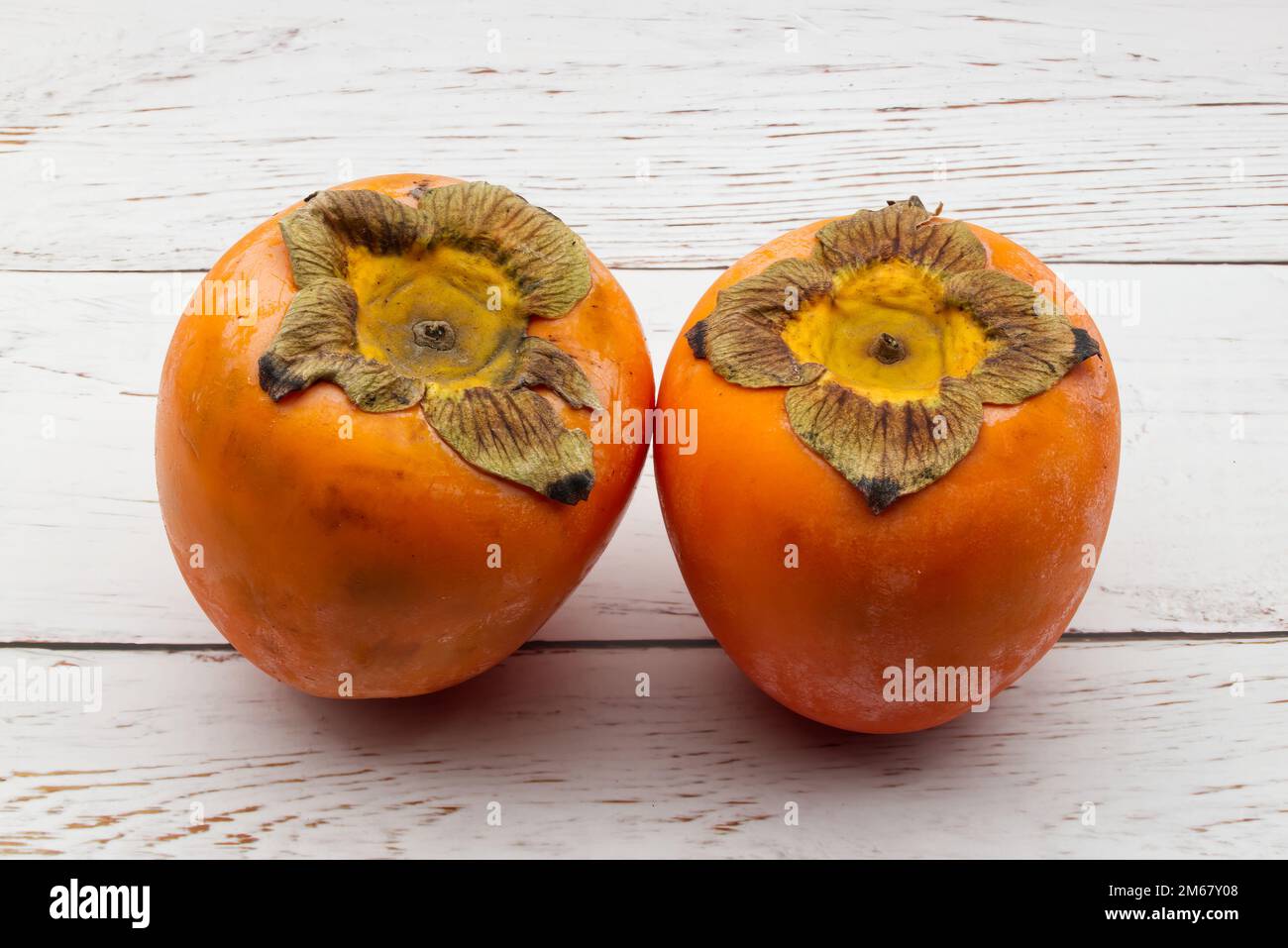 Fresh ripe persimmons isolated on white background Stock Photo