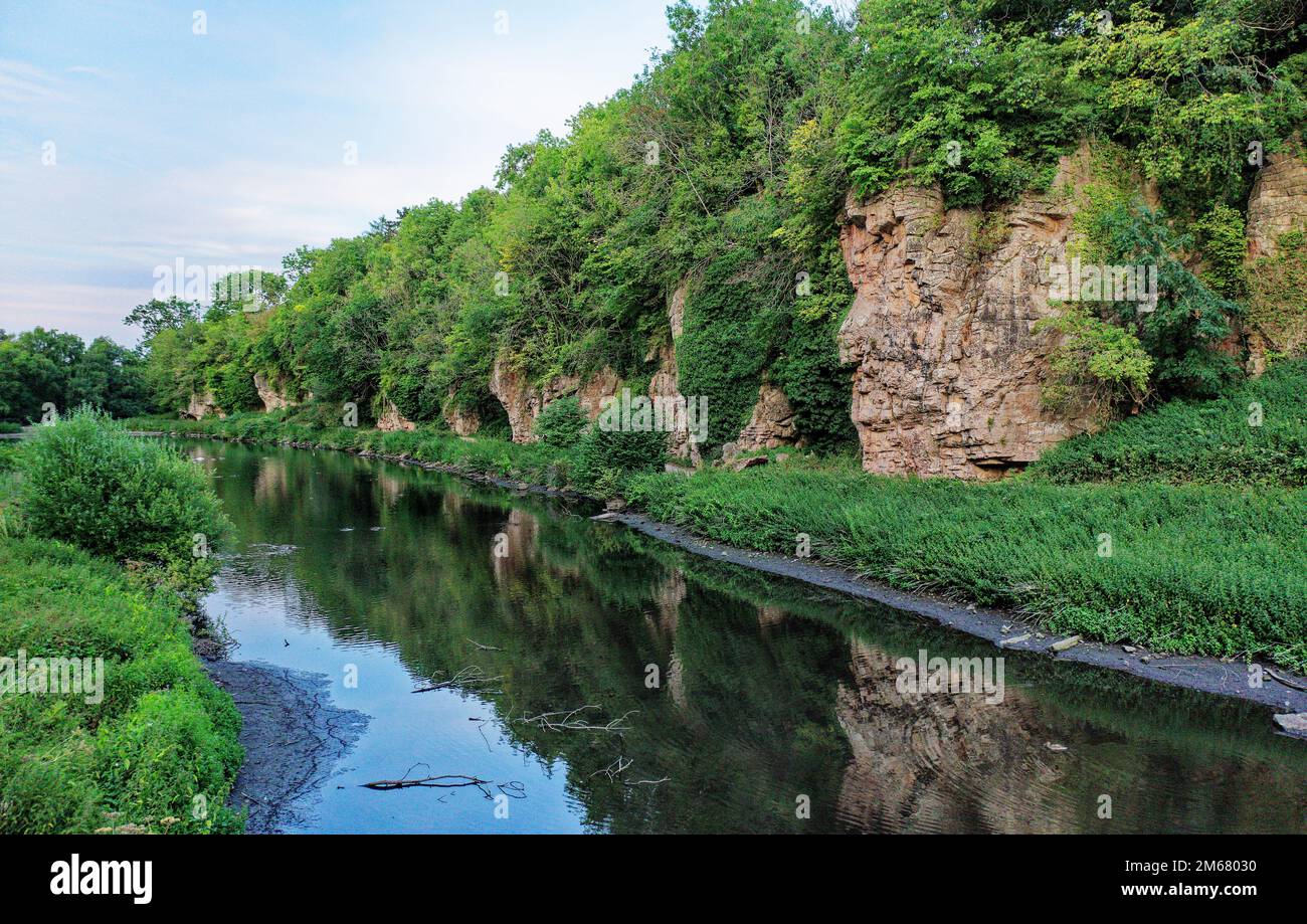 Creswell Crags prehistoric site. Caves both sides limestone gorge occupied 43,000 years from last Ice Age to 10,000 years ago. View E along S cliffs Stock Photo