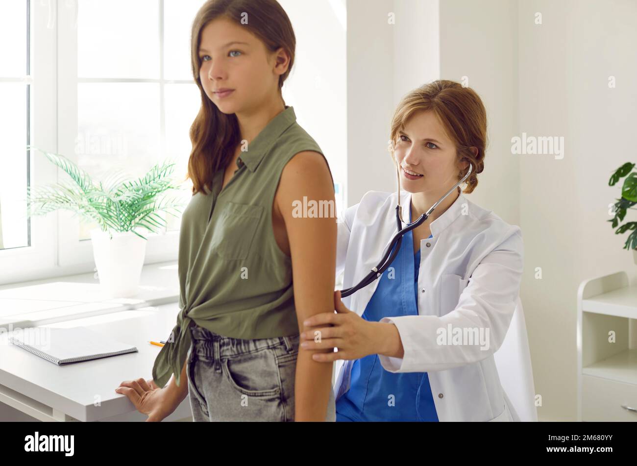 Teen Girl On Checkup Appointment With Young Woman Doctor Examining Her