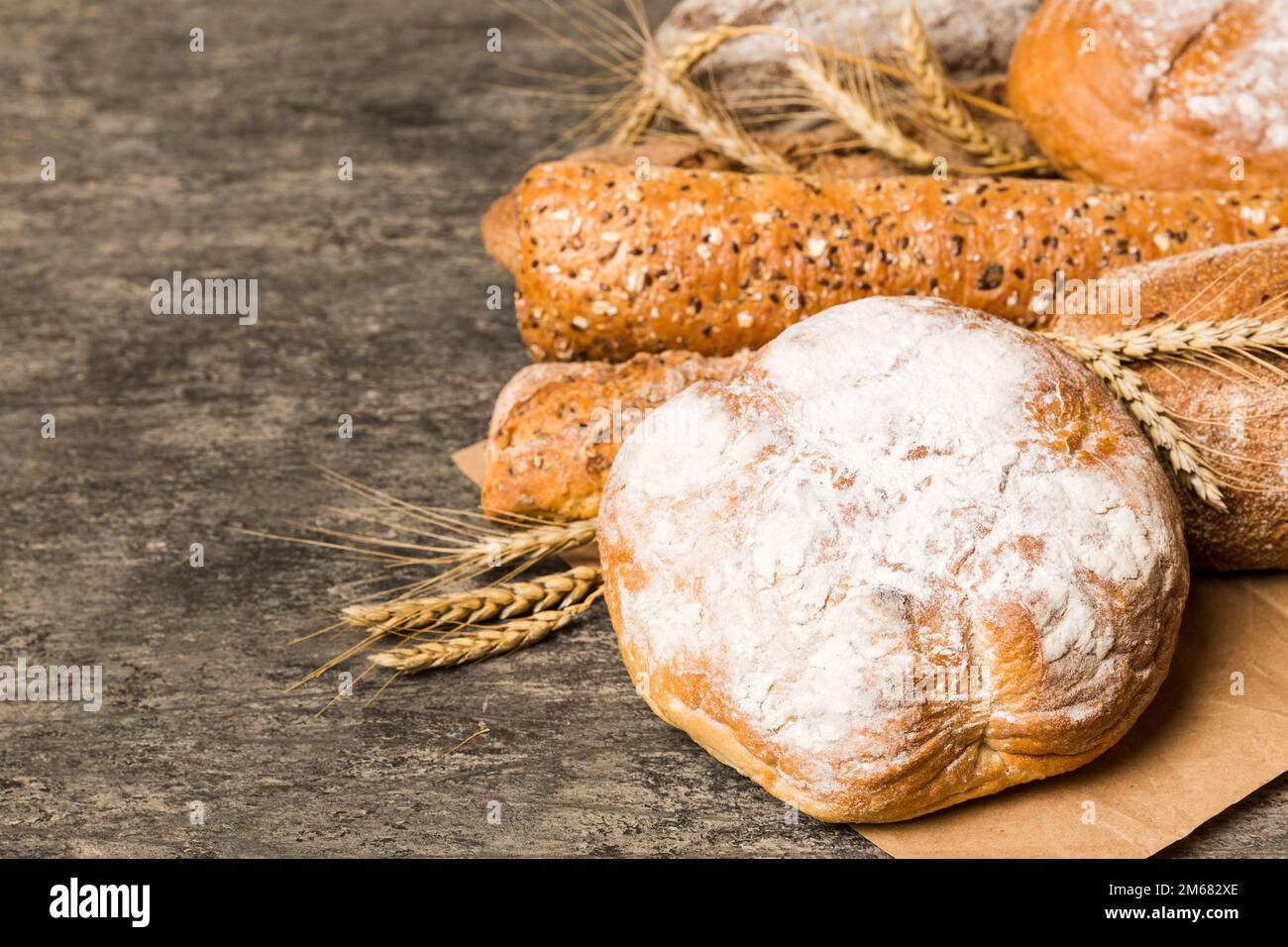 Homemade natural breads. Different kinds of fresh bread as background, perspective view with