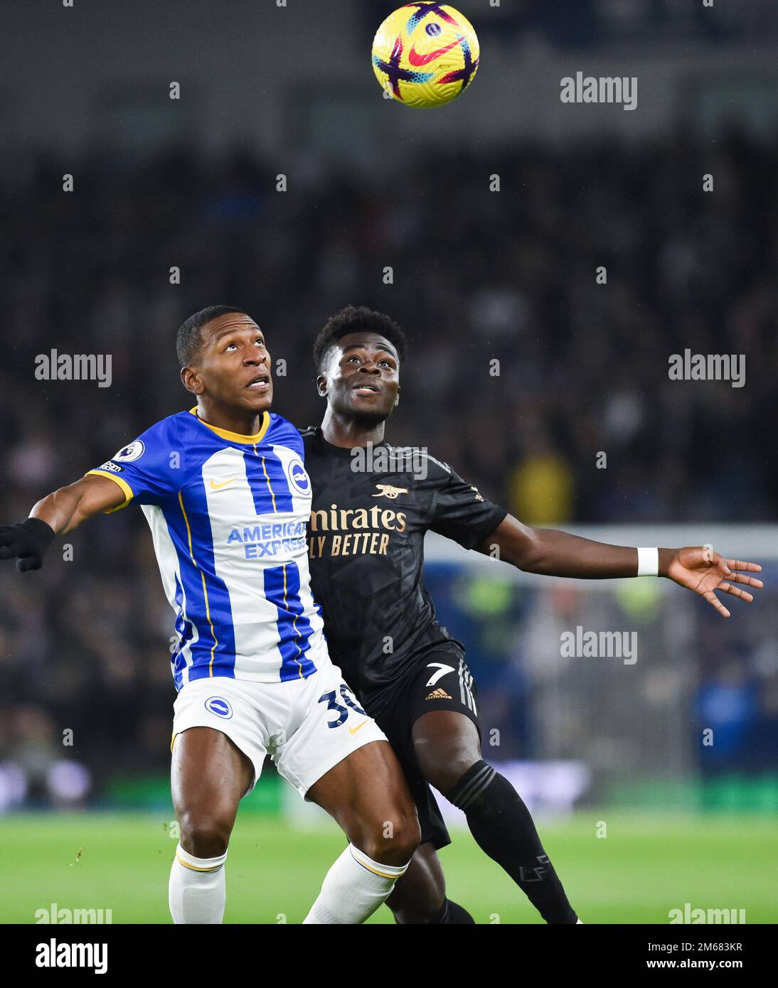 Pervis Estupinan of Brighton battles for the ball with Bukayo Saka of Arsenal during the Premier League match between Brighton & Hove Albion and  Arsenal at The American Express Community Stadium , Brighton , UK - 31st December 2022 Editorial use only. No merchandising. For Football images FA and Premier League restrictions apply inc. no internet/mobile usage without FAPL license - for details contact Football Dataco Stock Photo
