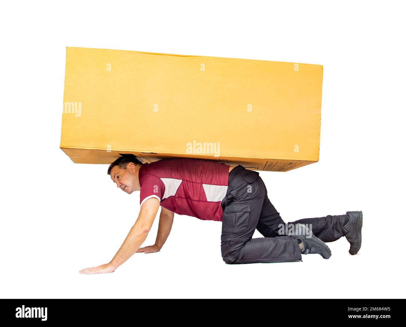 A man carries a big package, isolated on a white background. Stock Photo