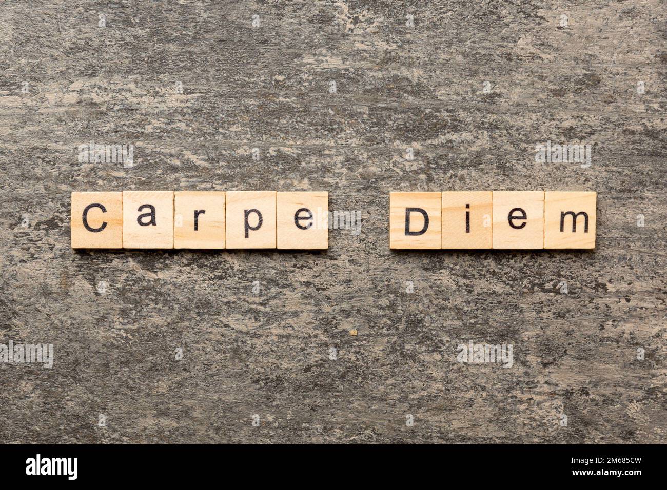 Carpe diem word written on wood block. Carpe diem text on table
