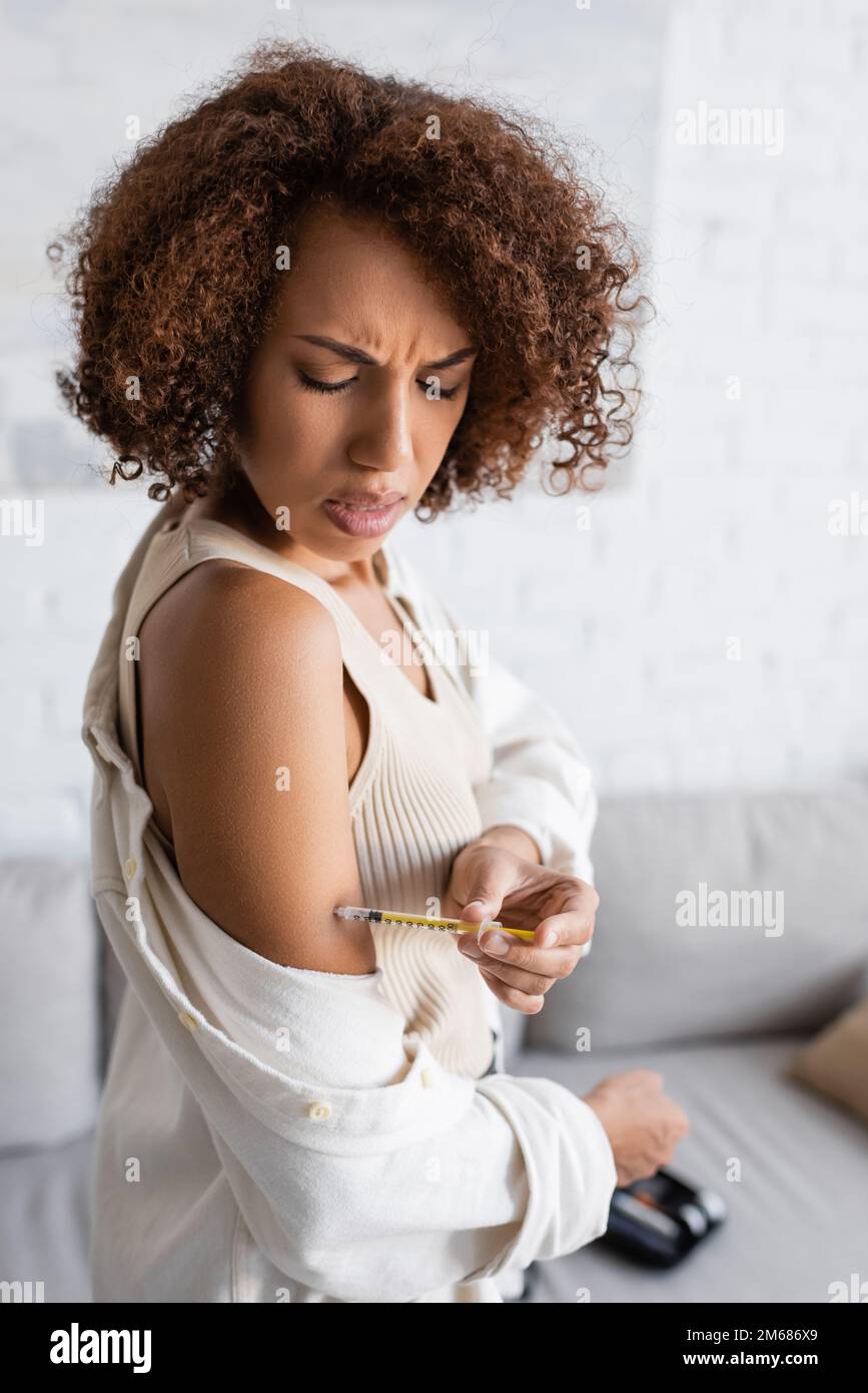 African american woman with diabetes feeling pain while doing insulin