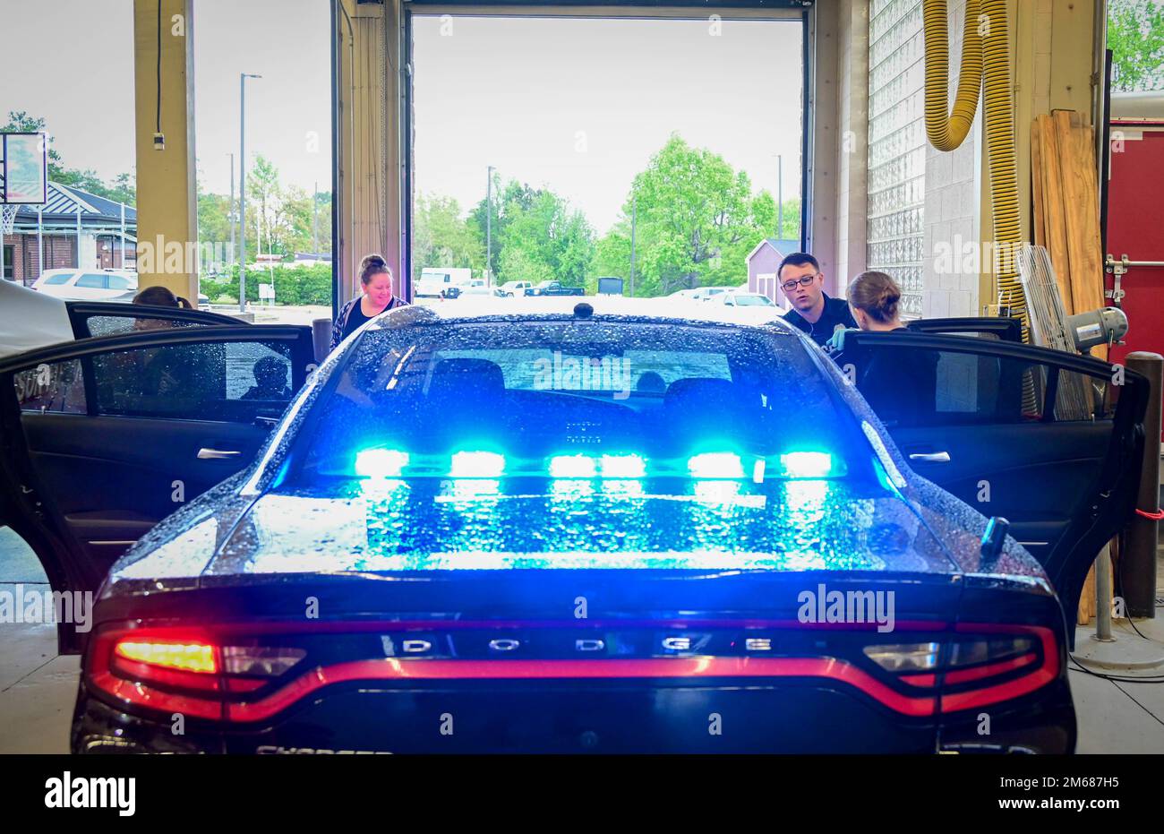 Fort Jackson community members explore a police cruiser during the Directorate of Emergency Services Open House April 16, 2022. Due to ongoing rain and cold winds, the event was moved inside of the fire department’s truck bays to keep attendees dry while getting a chance to see and meet the installation’s police, fire fighter and Emergency Medical Technician teams. Stock Photo