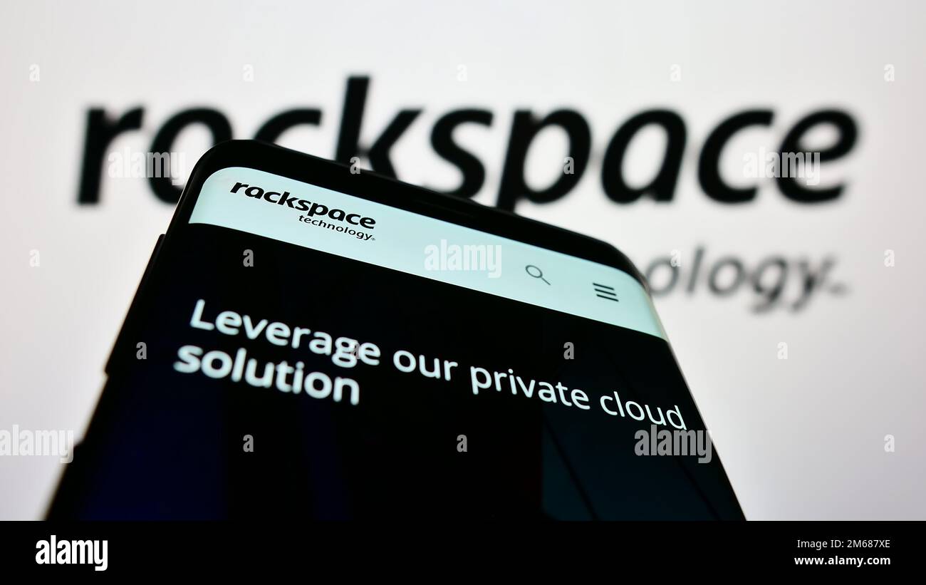 Smartphone with webpage of US data center company Rackspace Technology Inc. on screen in front of logo. Focus on top-left of phone display. Stock Photo