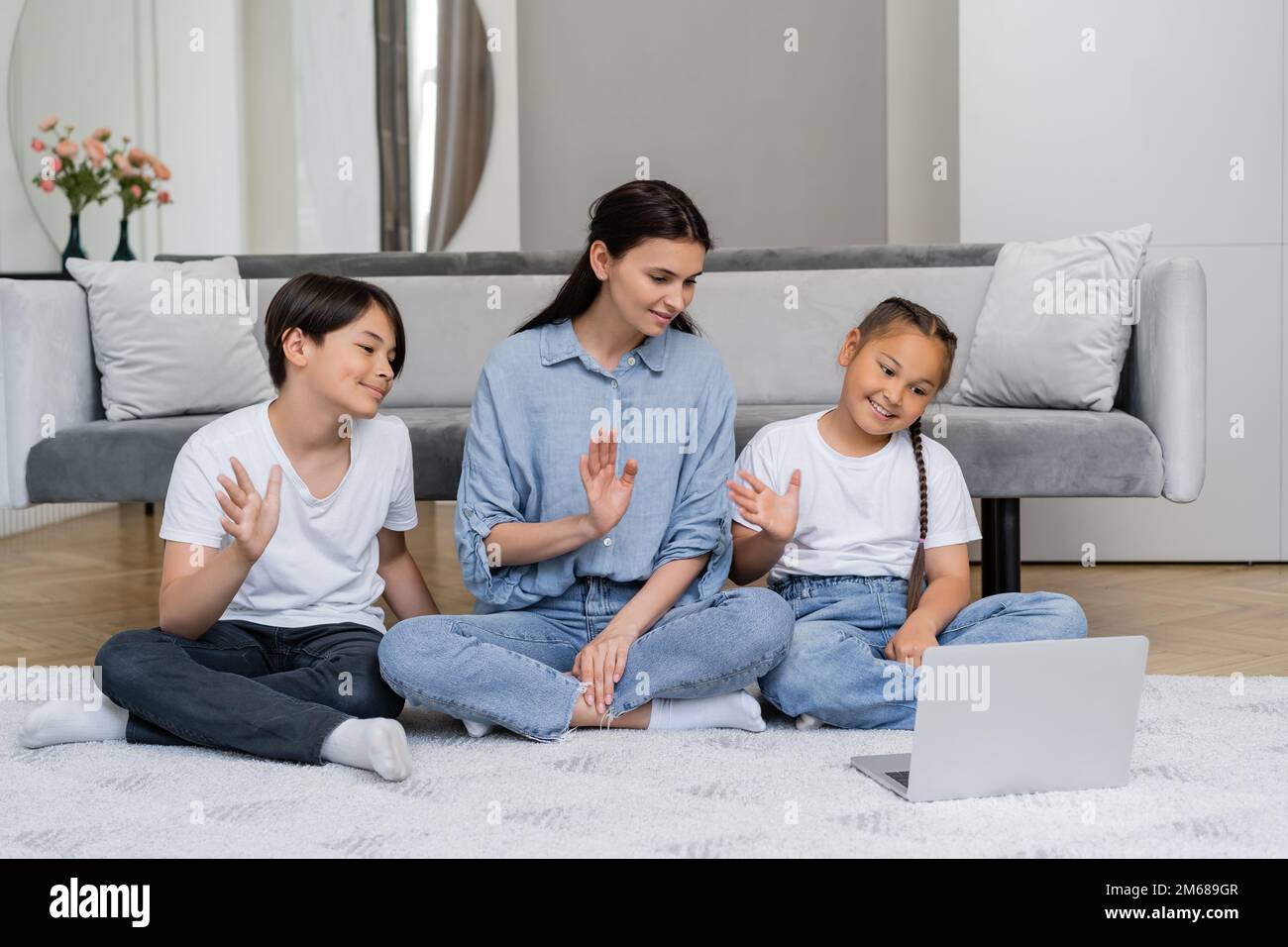 Smiling asian kids and parent having video call on laptop at home,stock image Stock Photo