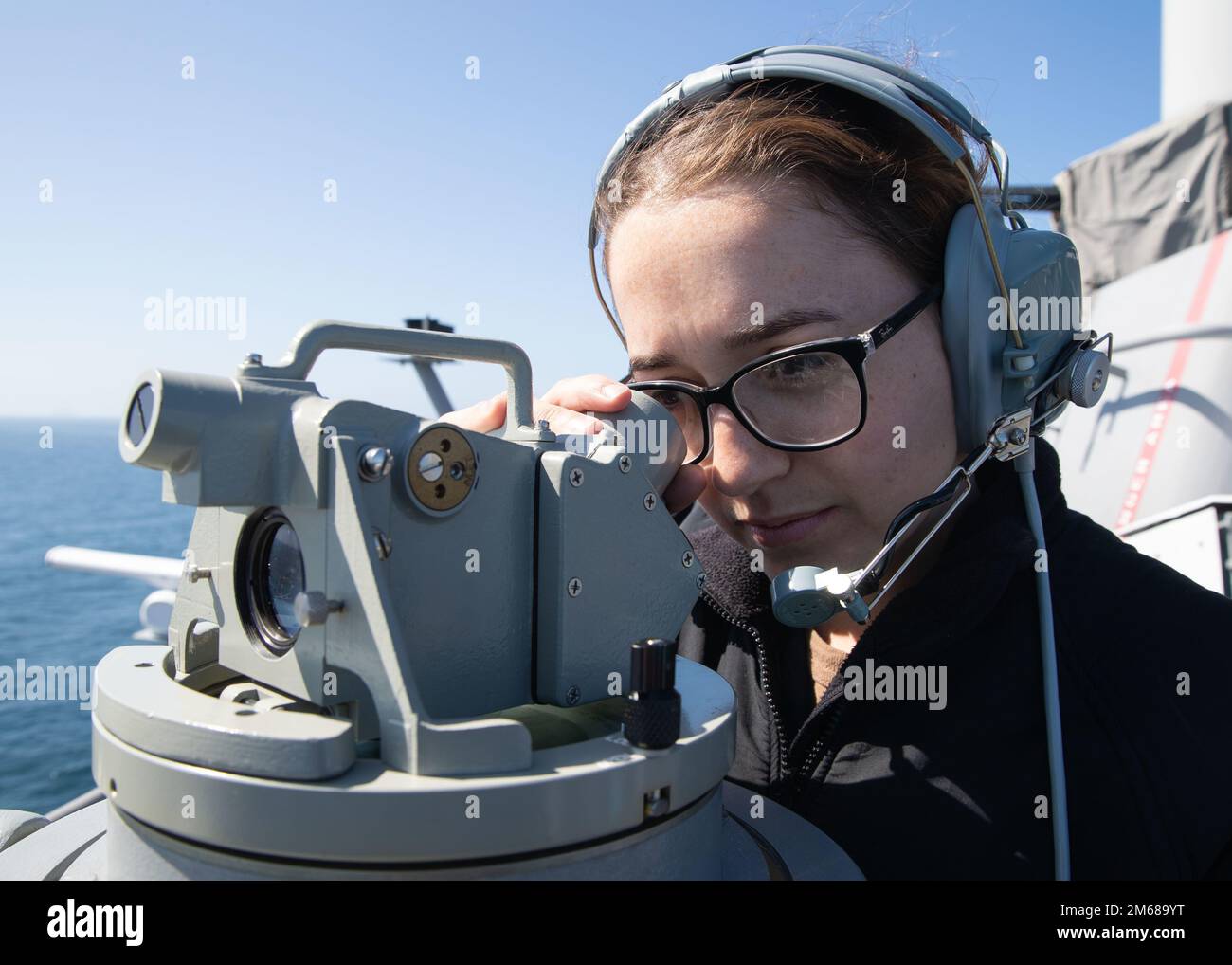 220418-N-TT639-2016 PACIFIC OCEAN (Apr. 18, 2022) – Quartermaster 3rd Class Kayla Nash, from New Braunfels, Texas, uses a telescopic alidade to determine amphibious assault ship USS Tripoli’s (LHA 7) position, April 18, 2022. Tripoli is underway conducting routine operations in U.S. 3rd Fleet. Stock Photo