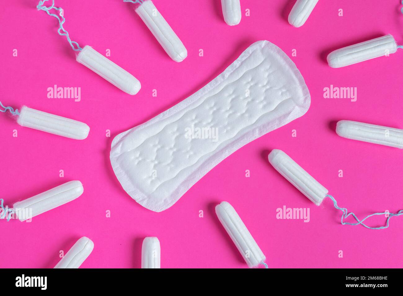 Menstrual tampons and pads on a pink background. Menstruation cycle