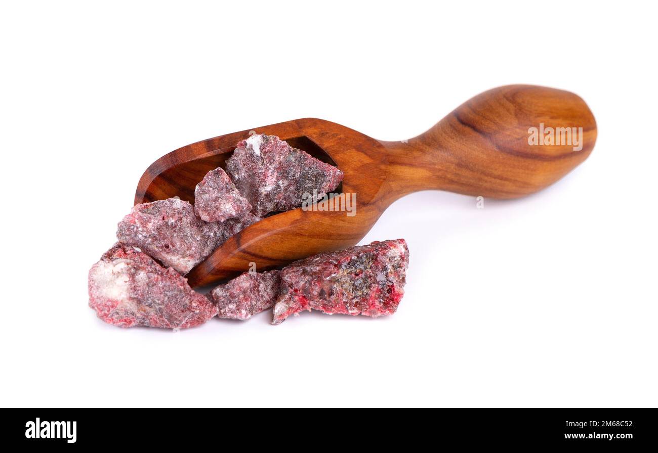 Benzoin Siam resinoid in wooden spoon, isolated on white background. Mix of benzoin and Dammar resin. Tropical resins. Top view Stock Photo
