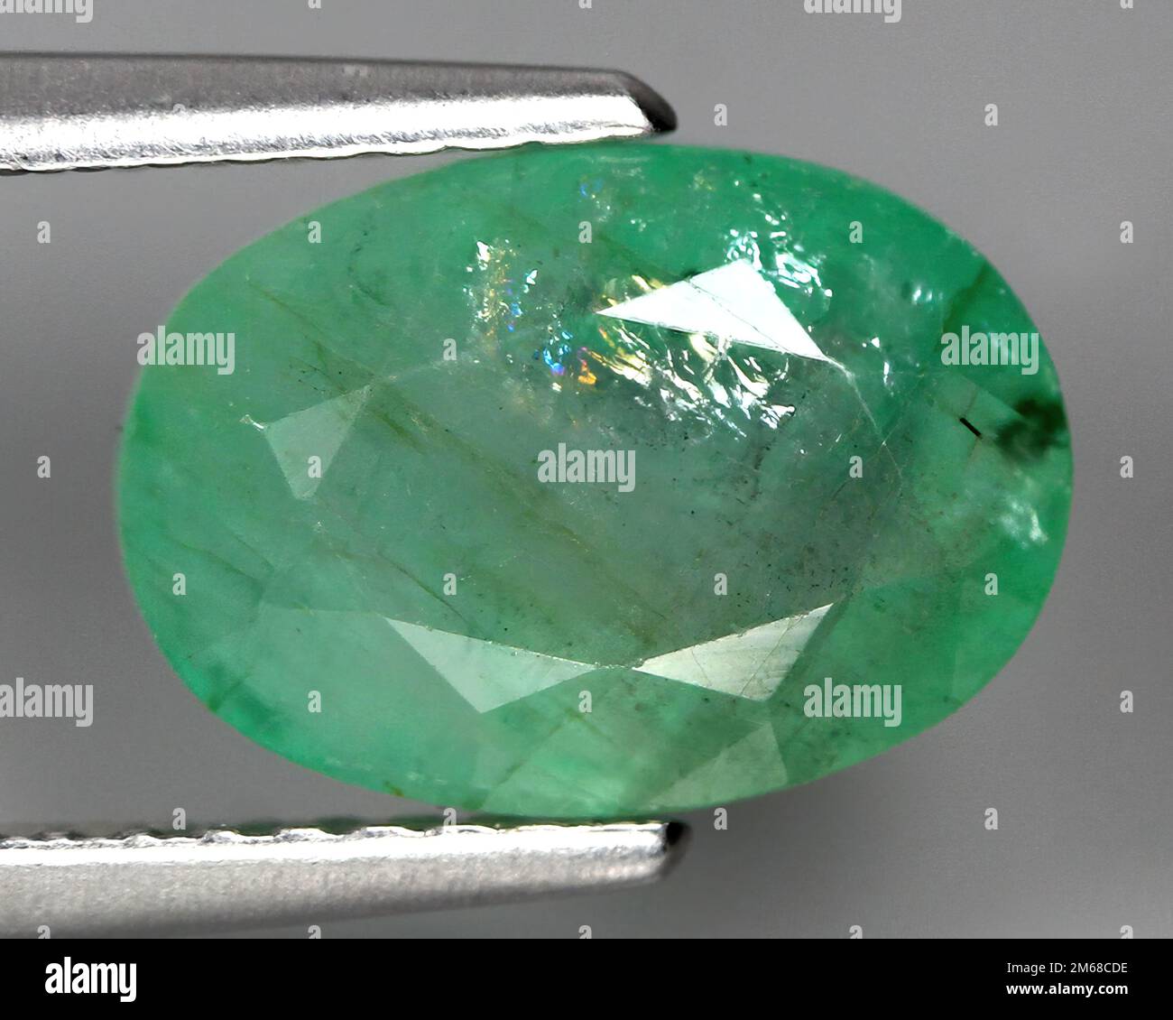 Natural stone green emerald on a gray background Stock Photo Alamy