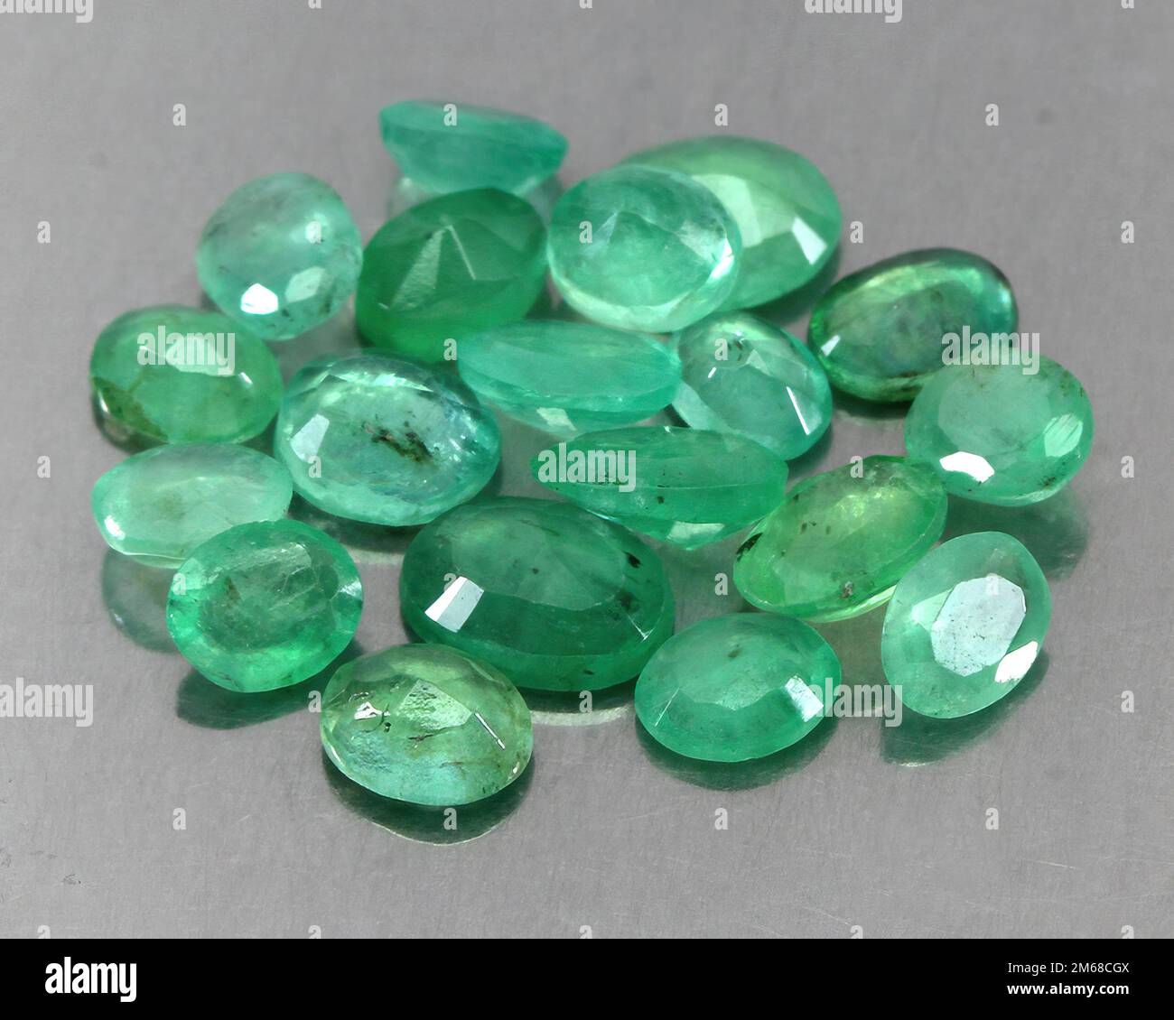 Natural stone green emerald on a gray background Stock Photo