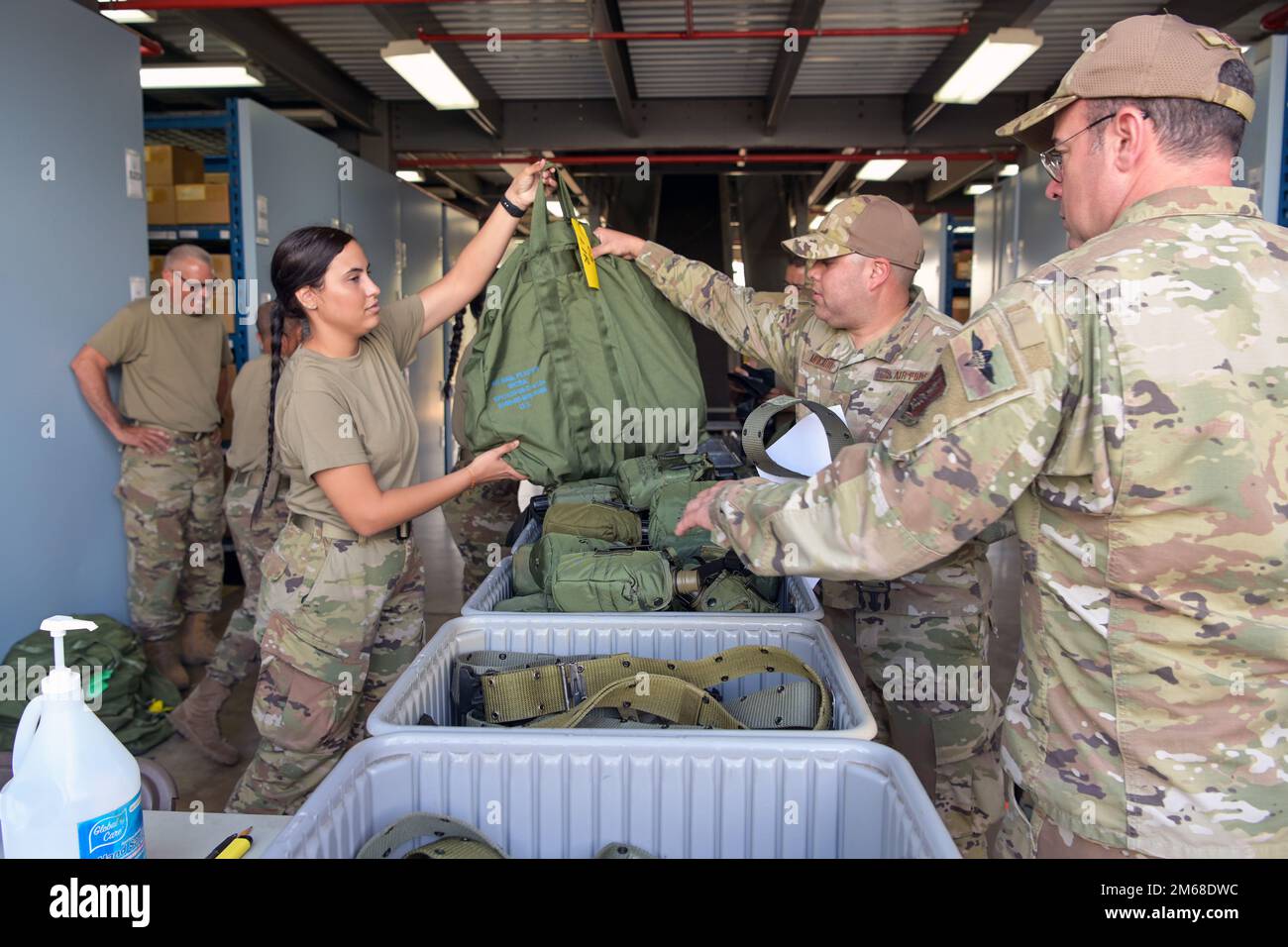 U.S. Airman 1st Class Alondra Vega, a material management apprentice, with the 156th Logistics Readiness Squadron, issues a chemical, biological, radiological and nuclear protective equipment bag to Master Sgt. Radames Mercado, a radio frequency transmission journeyman with the 156th Contingency Response Group, April 18, 2022, at Muñiz Air National Guard Base, Puerto Rico. The material management specialists with the 156th LRS processed each piece of CBRN equipment out of the mobility warehouse, focused on ensuring Airmen with the 156th CRG attending Southern Strike 2022 were issued the correc Stock Photo