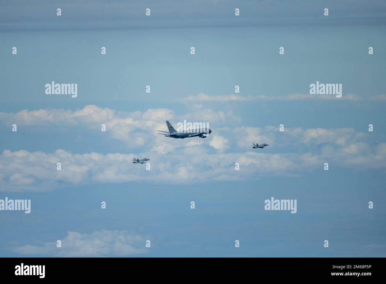 A Spanish Air Force C15 approaches a U.S. Air Force KC46A Pegasus for