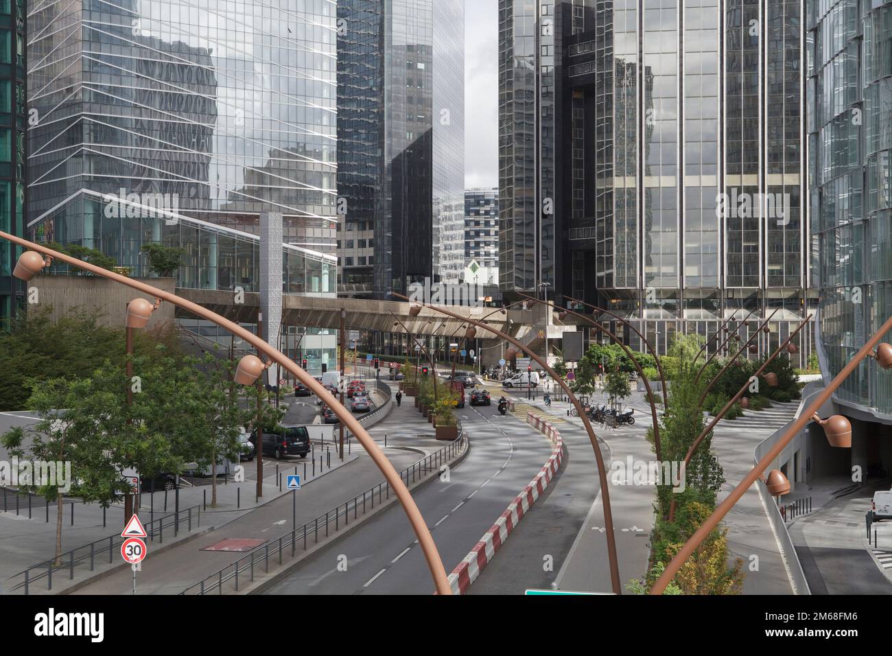 A road running through the skyscrapers of La Defense, the business district of Paris Stock Photo