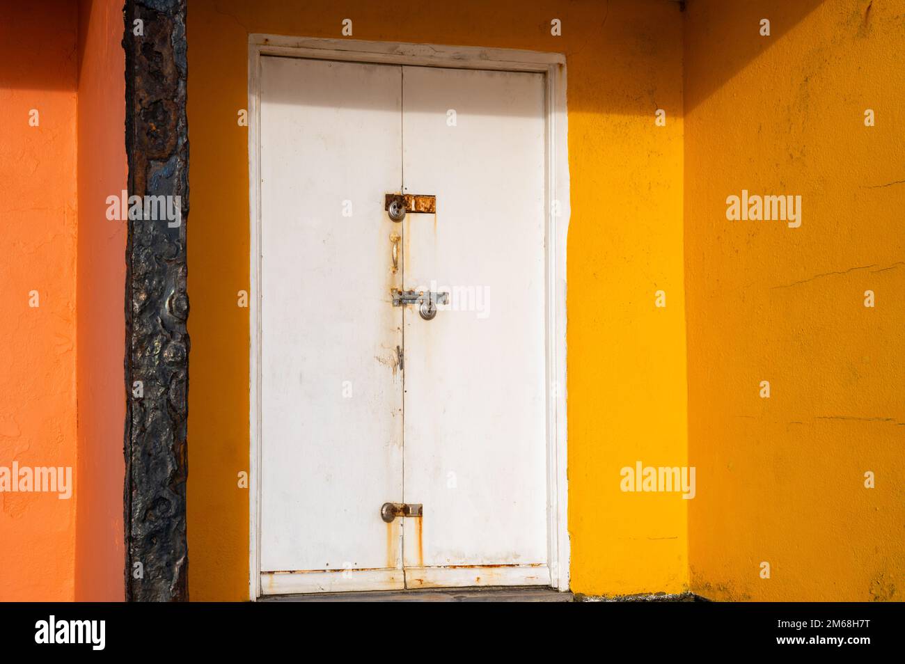 Yellow beach hut with metal doors at BexhillonSea, East Sussex