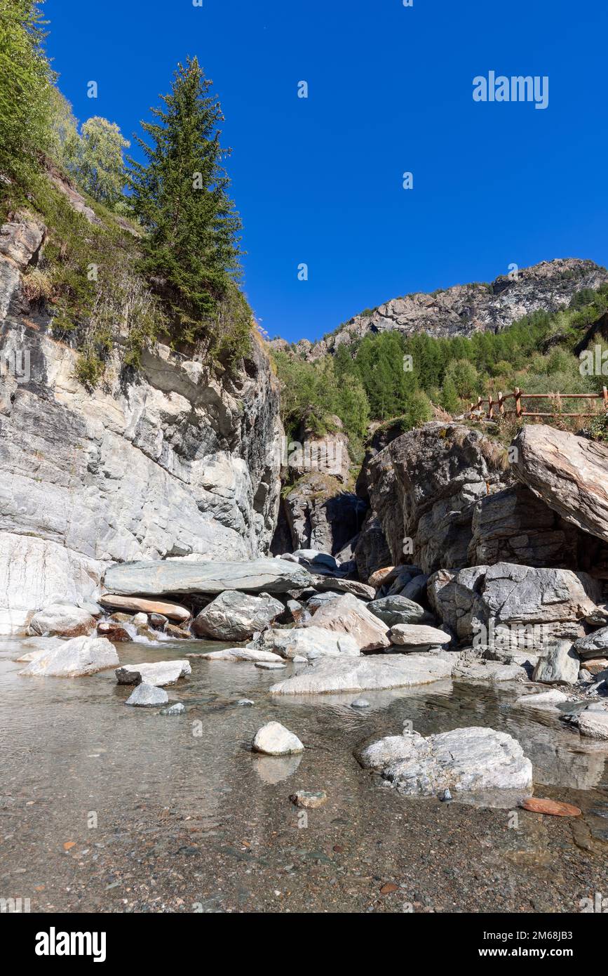 Pond With Crystal Water And Small Pebbles Formed By Lillaz Waterfall