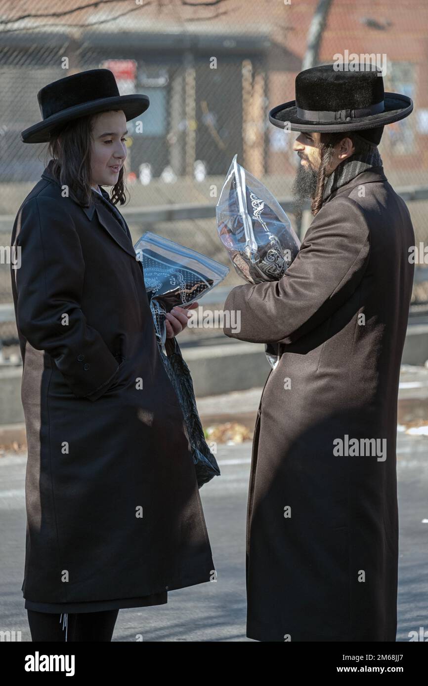 Friend encounter & talk on the way home from morning prayer services. In Brooklyn, New York City. Stock Photo