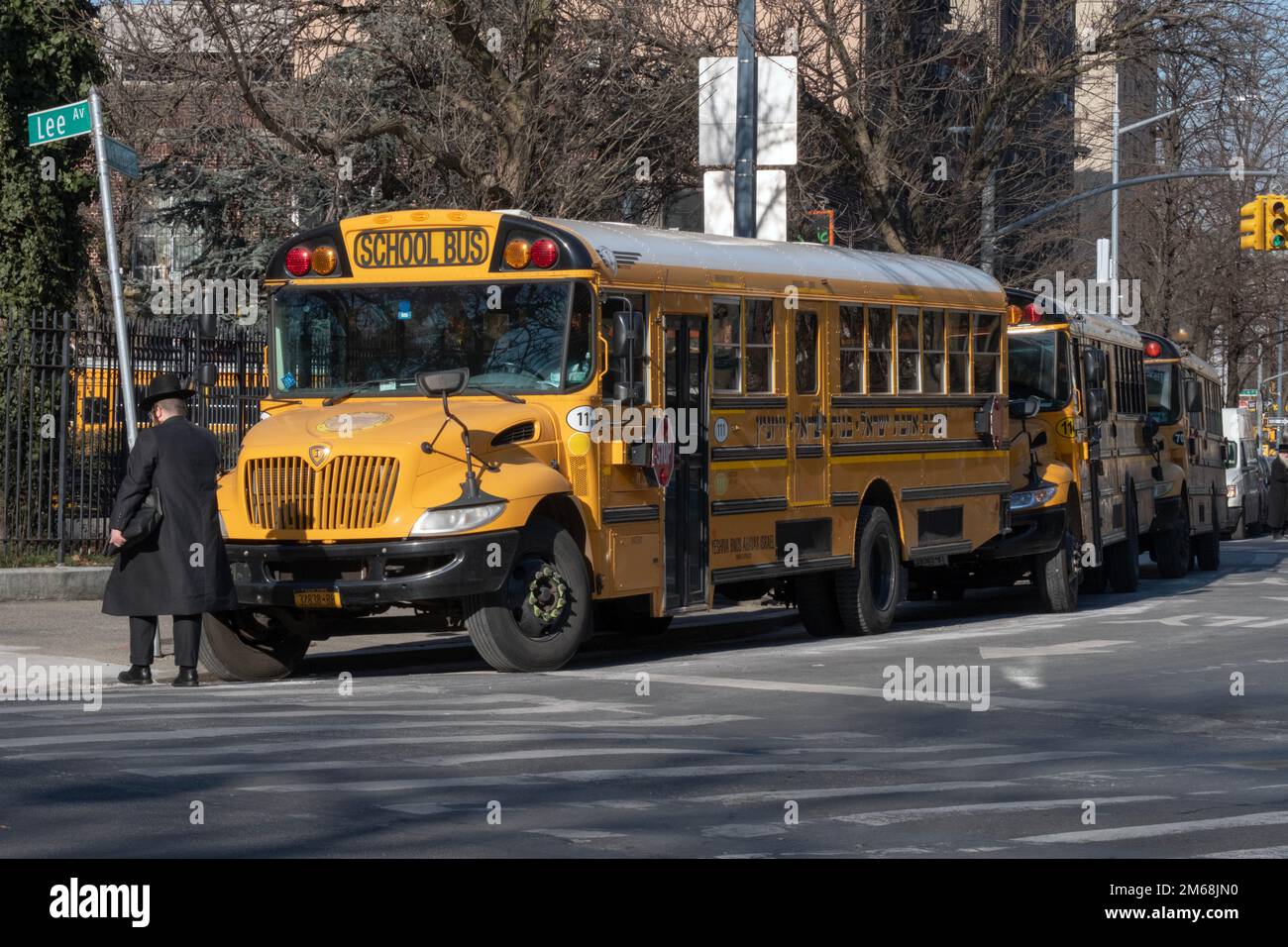 3 parked Vizhnitz school busses on Roebling Street near Lee avenue in Williamsburg, Brooklyn New York City. Stock Photo