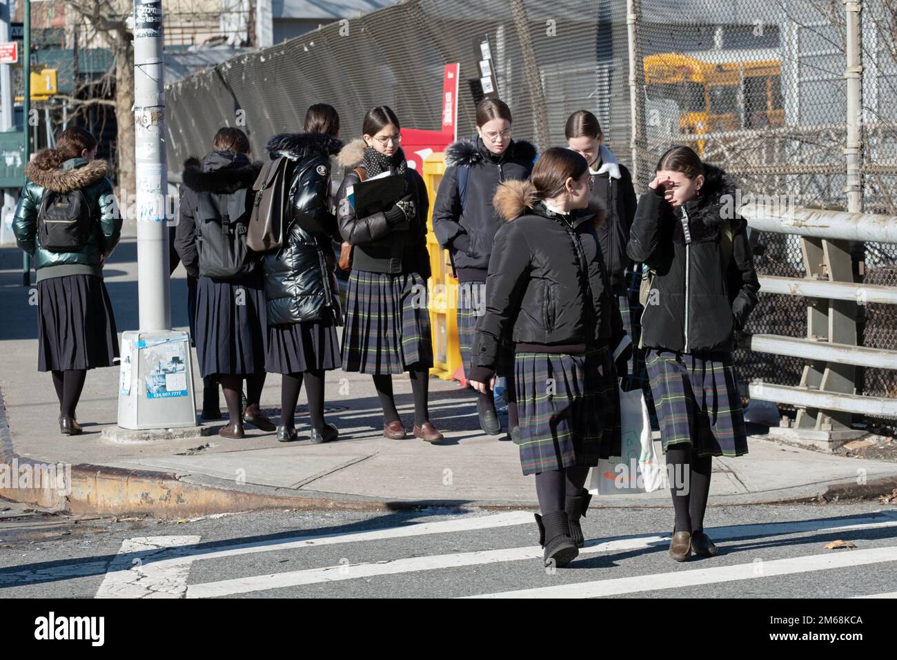 Orthodox jewish school girls wearing their uniform, return home after classes. There are 2 groups, each with different skirts. In brooklyn, New York. Stock Photo