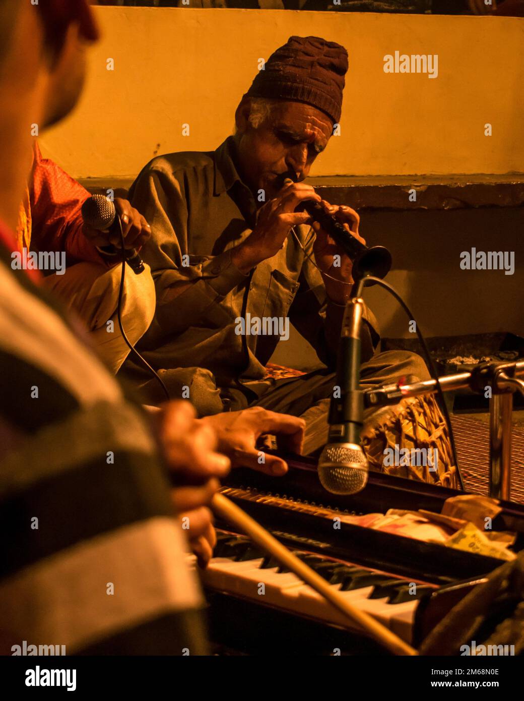 A vertical shot of an Indian musician playing a shehnai during a ...