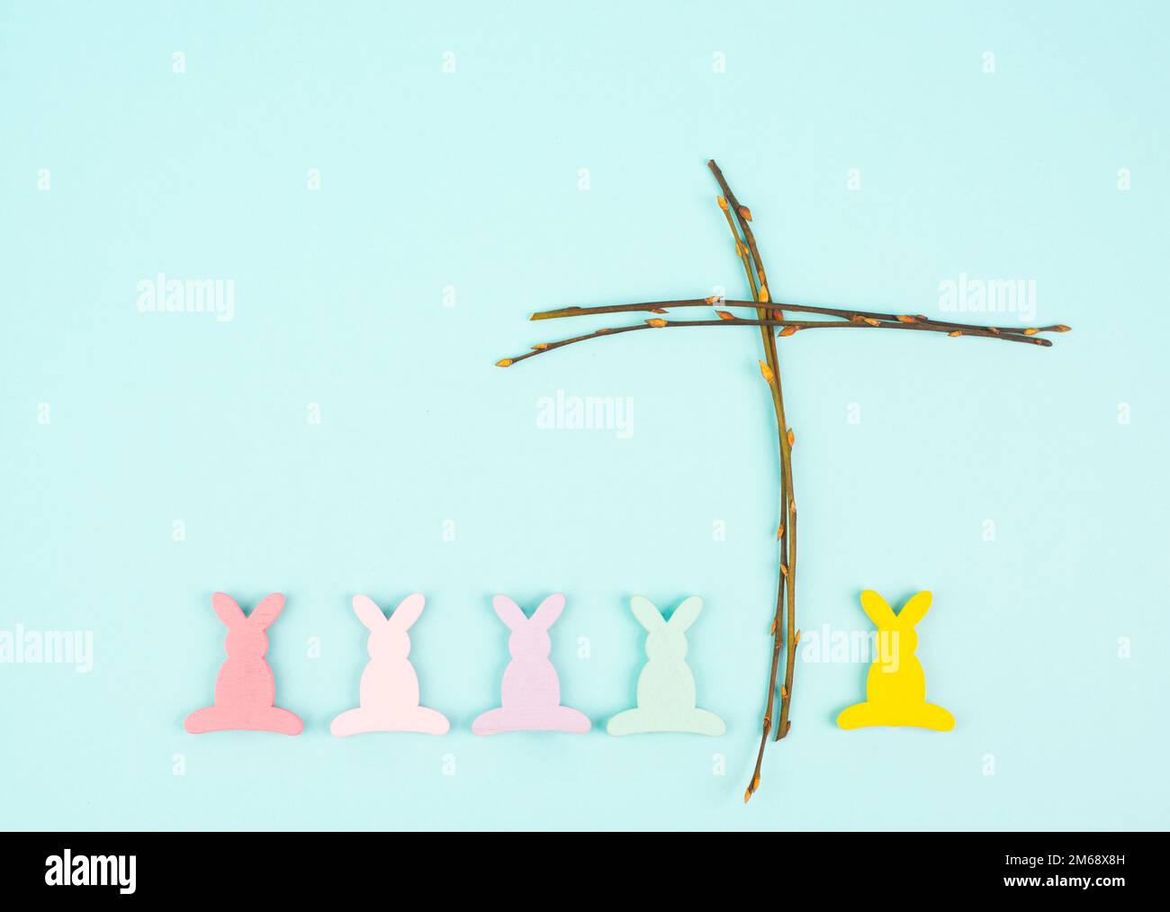 Easter bunny or rabbit with a religious cross made from willow branches
