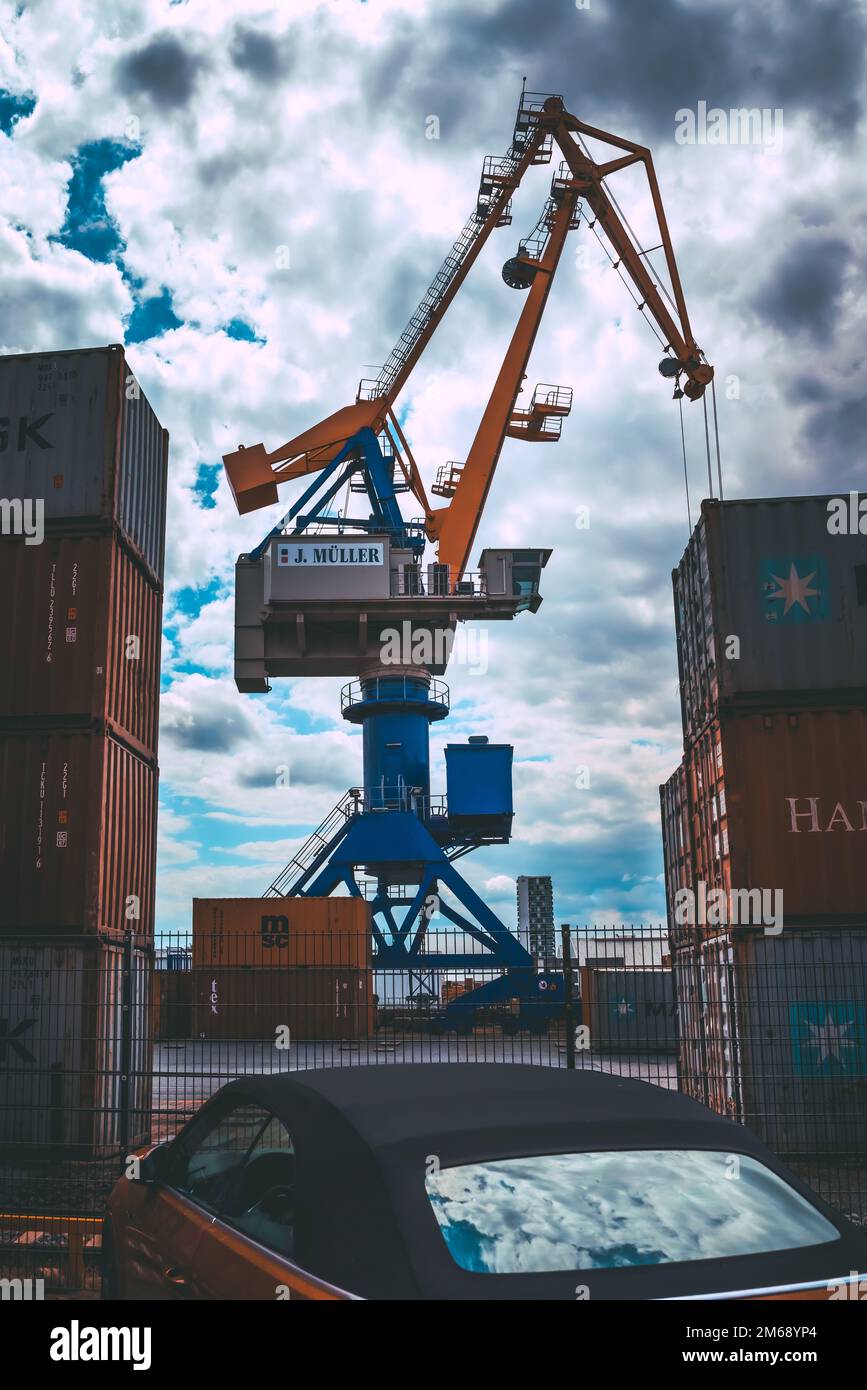 A vertical shot of the unloading crane with containers in the port of ...