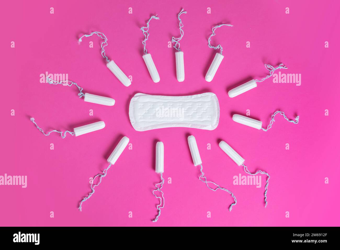 Menstrual tampons and pads on a pink background. Menstruation cycle