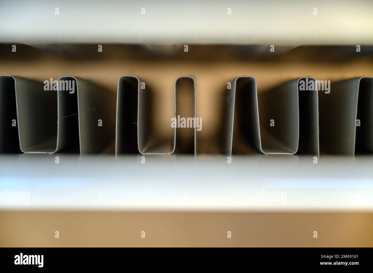 View of a home double panel convector radiator (or heat convector) seen from above. Shallow depth of field focusing on the internal convector fins. Stock Photo