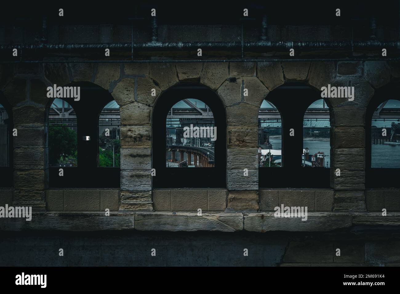 A walking bridge and railway with arched window parts Stock Photo - Alamy