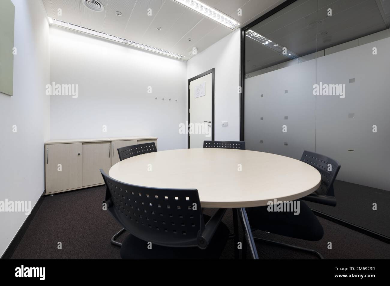 Conference office with blackboard with erasable markers, round table