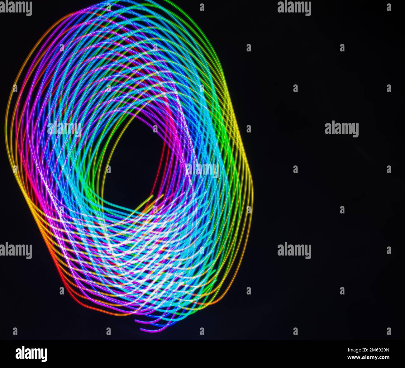 Beautiful light painting designs on dark black background. Long exposure patterns on black Stock ...