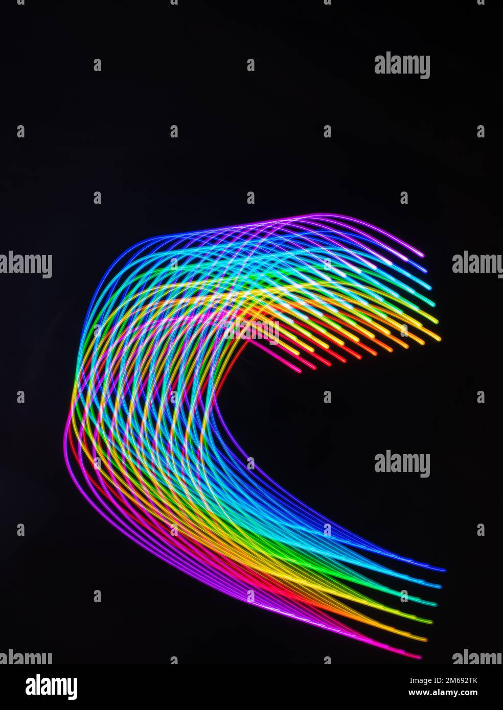 Beautiful light painting designs on dark black background. Long exposure patterns on black Stock ...