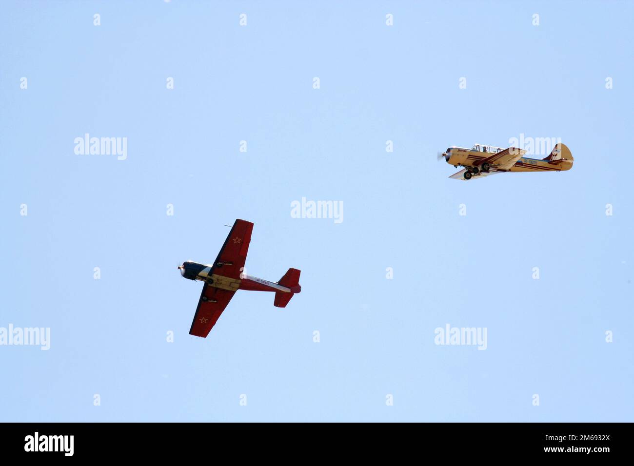 Two propeller-driven airplanes on clear sky background 2 Stock Photo ...