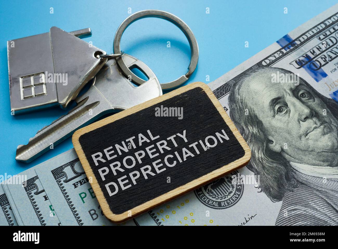 Key, cash and plate with sign Rental property depreciation. Stock Photo