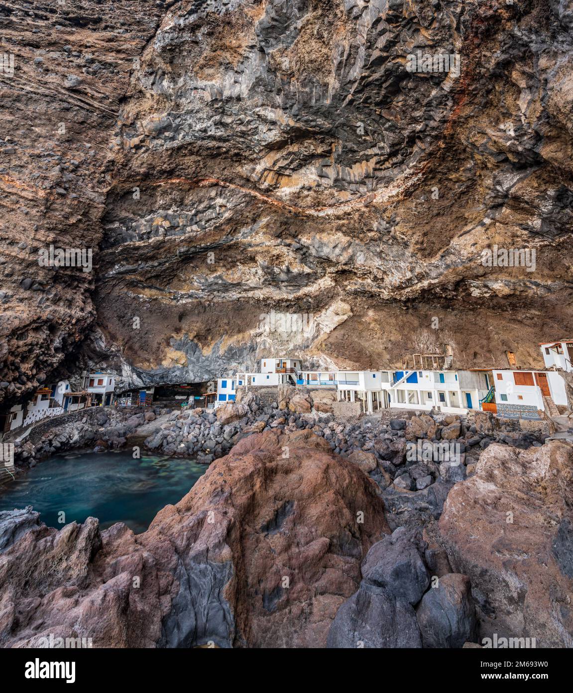 A fishing village under the rough rocks Stock Photo