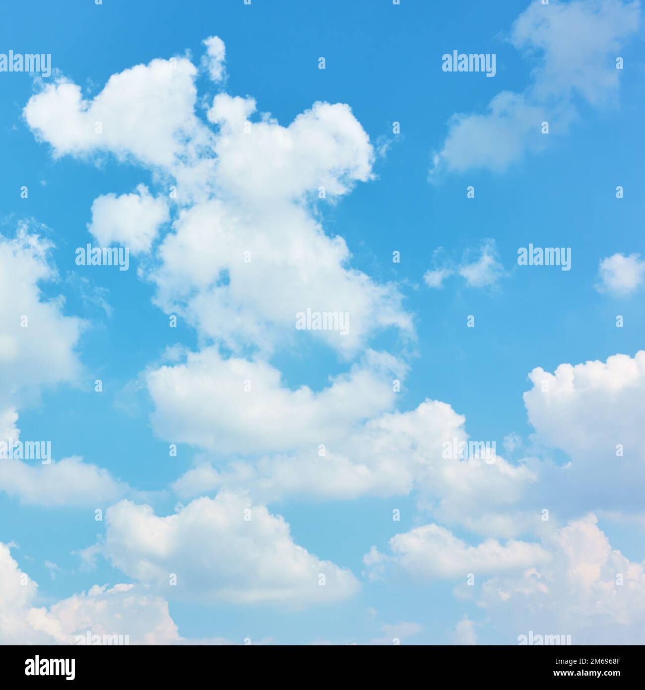 White heap clouds in the blue sky - background, cloudscape Stock Photo