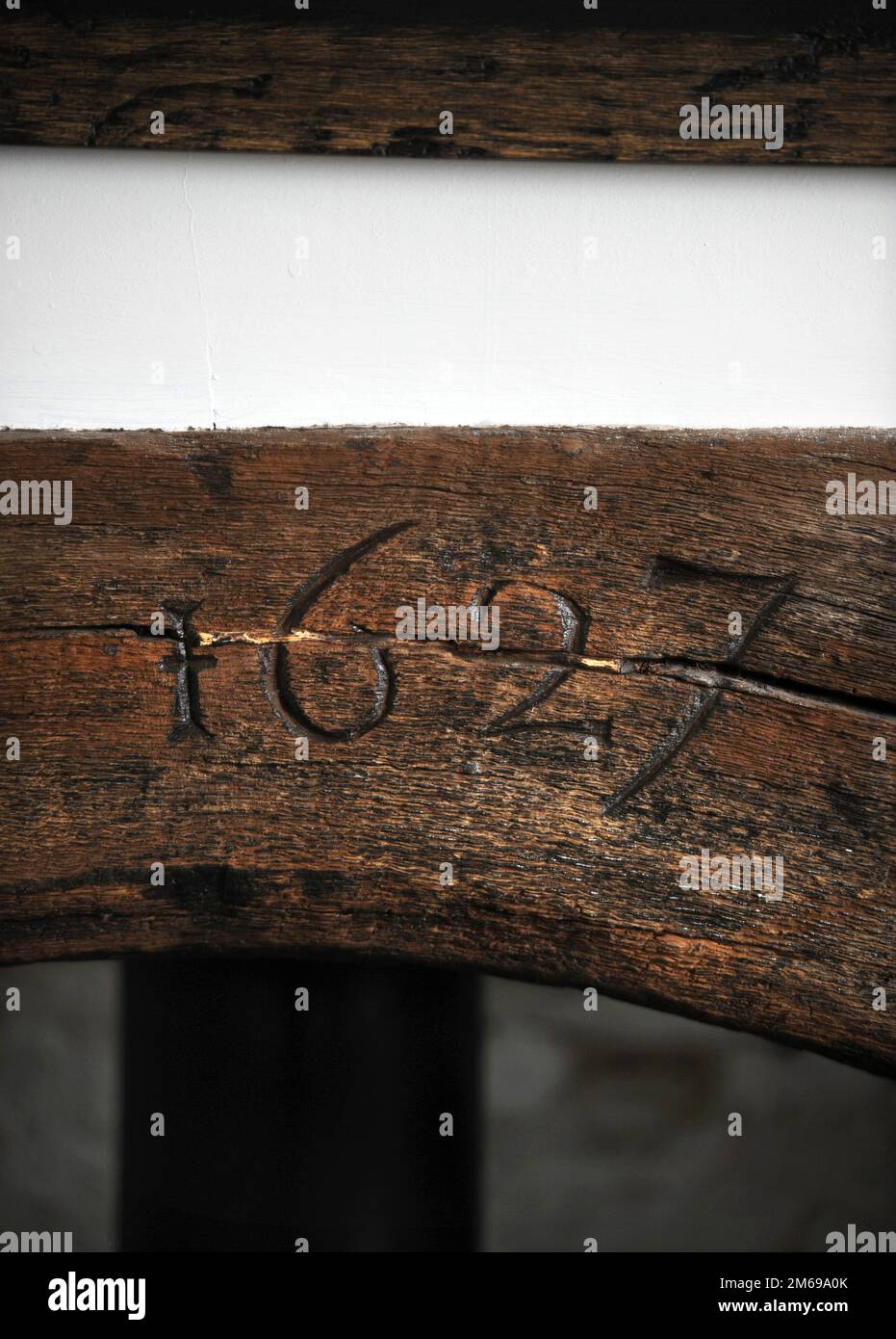 The date 1627 carved into a lintel above the fireplace. Stock Photo