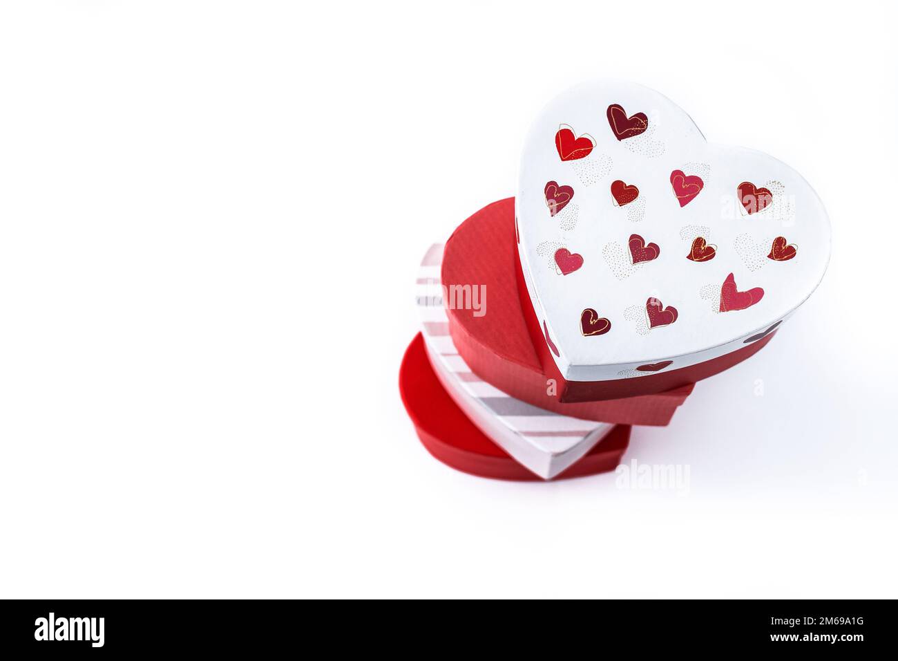 Heart shaped boxes decorated with pink and red hearts isolated on white
