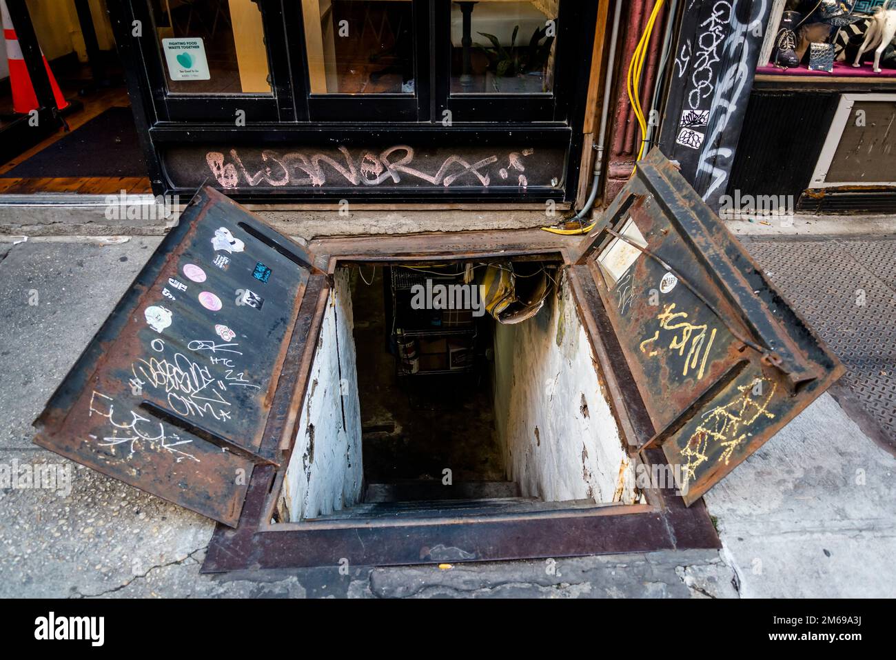 Open cellar door in the sidewalk, The Bowery, a historic neighbourhood