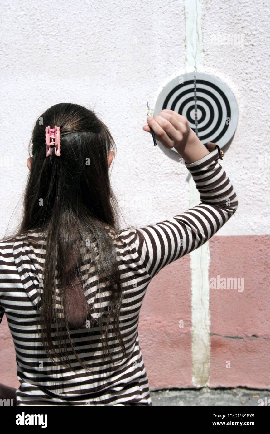 Girl throws javelin to dartboard 2 Stock Photo Alamy