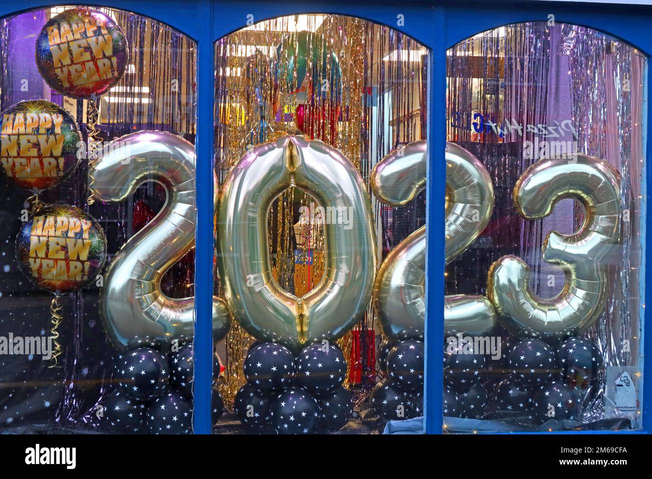 Happy New Year 2023, balloons in a shop window, 753 Knutsford Road, Latchford, Warrington, Cheshire, England, UK, WA4 1JY Stock Photo