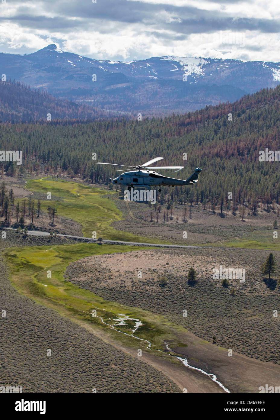 An Mh-60R Seahawk attached to Helicopter Maritime Strike Squadron (HSM) 46 flies a daytime familiarization flight during a training detachment at Naval Air Station Fallon, April 20, 2022. Carrier Air Wing (CVW) 7 is the offensive air and strike component of Carrier Strike Group (CSG) 10 and the George H.W. Bush CSG. The squadrons of CVW-7 are Strike Fighter Squadron (VFA) 143, VFA-103, VFA-86, VFA-136, Electronic Attack Squadron (VAQ) 140, Carrier Airborne Early Warning Squadron (VAW) 121, HSC-5, and Helicopter Maritime Strike Squadron (HSM) 46. Stock Photo