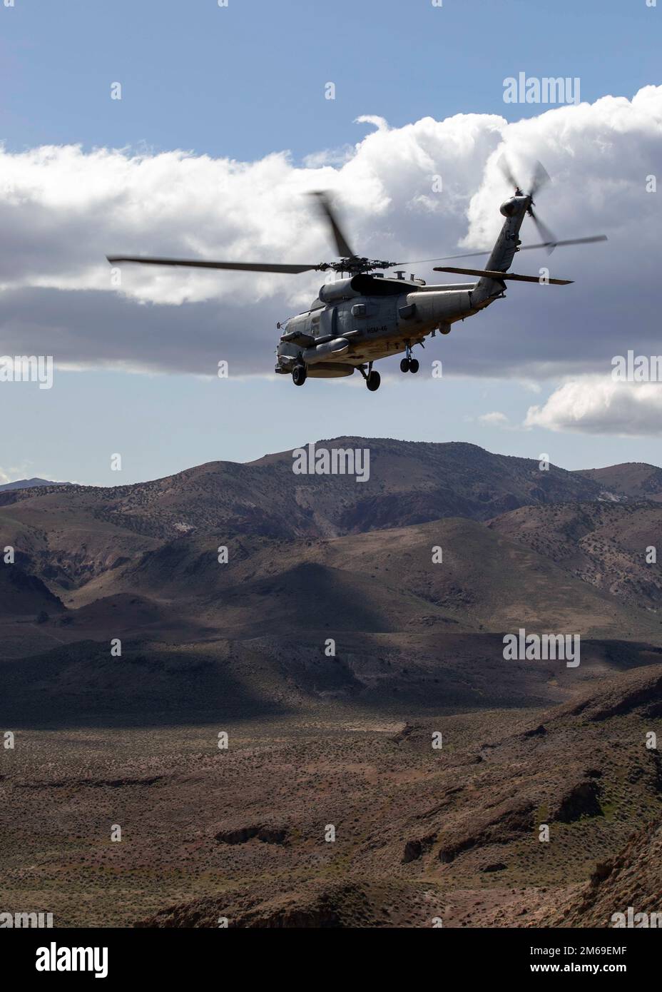 An Mh-60R Seahawk attached to Helicopter Maritime Strike Squadron (HSM) 46 flies a daytime familiarization flight during a training detachment at Naval Air Station Fallon, April 20, 2022. Carrier Air Wing (CVW) 7 is the offensive air and strike component of Carrier Strike Group (CSG) 10 and the George H.W. Bush CSG. The squadrons of CVW-7 are Strike Fighter Squadron (VFA) 143, VFA-103, VFA-86, VFA-136, Electronic Attack Squadron (VAQ) 140, Carrier Airborne Early Warning Squadron (VAW) 121, HSC-5, and Helicopter Maritime Strike Squadron (HSM) 46. Stock Photo