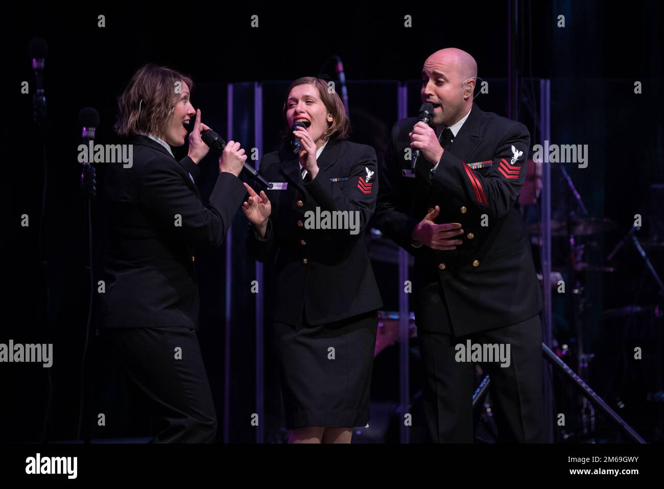 PITTSBURGH (April 20, 2022)  Musicians 1st class Maia Rodriguez, left, from Cleveland, Ohio, Madilyn Crossland, from Fremont, California, and Dennys Moura, from Gaithersburg, Maryland, sing together during a 'Music in the Schools' concert  at the Pittsburgh Creative and Performing Arts magnet high school. The United States Navy Band Sea Chanters chorus  performed in seven states during its 13-city, 2,000-mile tour, connecting communities across the nation to their Navy. Stock Photo