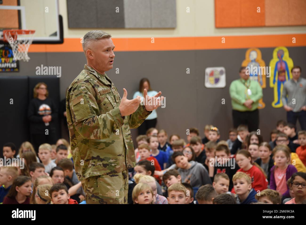 First Sergeant Drew Wagner talks to students at a home event in