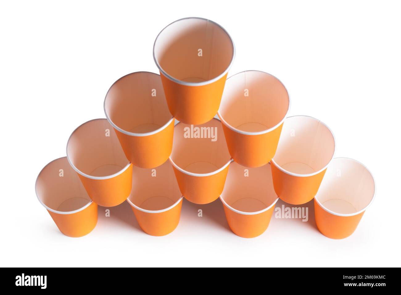 Pyramid of orange disposable paper cups isolated on white background. Stock Photo