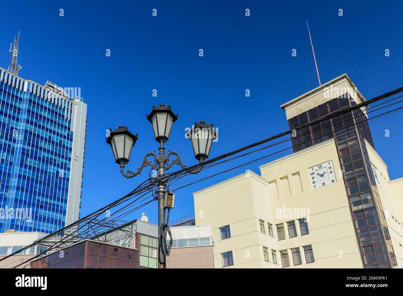 Lamppost on the background of buildings and the sky. The photo was taken in Chelyabinsk, Russia. Stock Photo